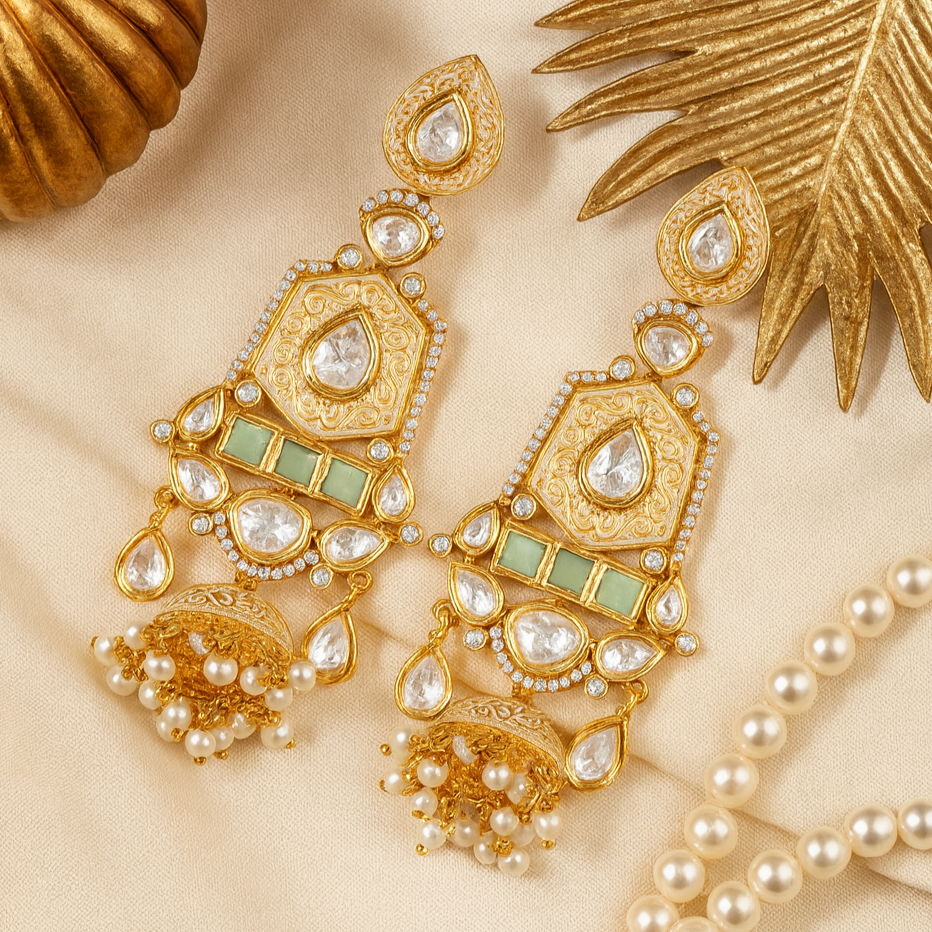 Gold jewelry set with earrings and necklace on a beige background
