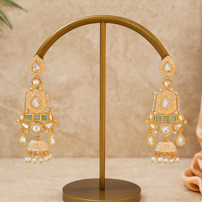 Gold earrings on a stand with a beige background
