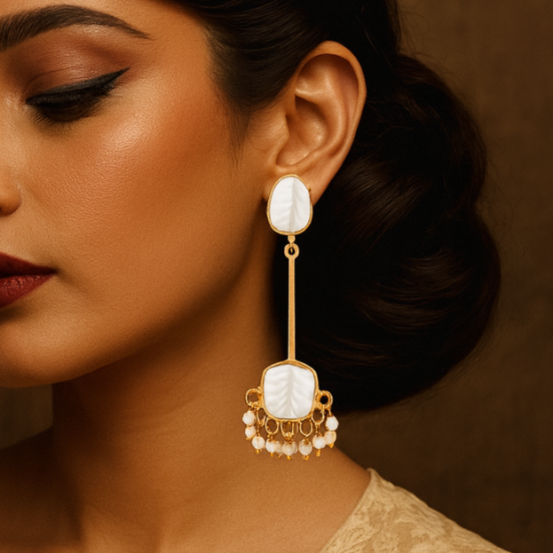 Woman wearing elegant earrings with a neutral background