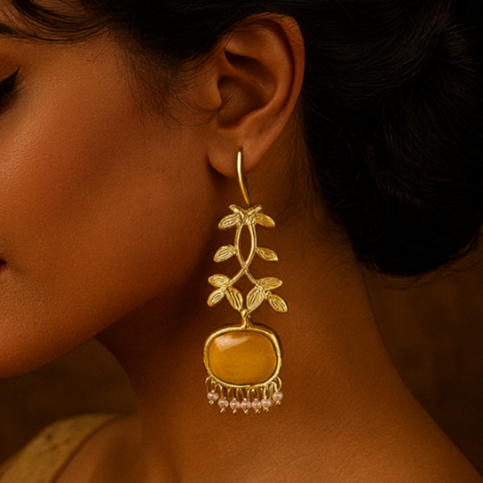 Woman wearing a gold earring with a brown background