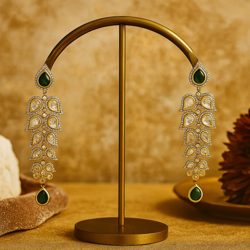 Ornate earrings on a gold stand against a warm brown background