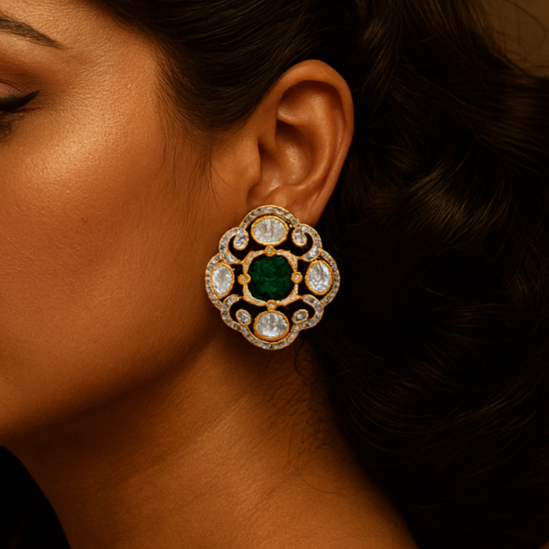 Woman wearing a large, ornate earring with a green gemstone against a brown background