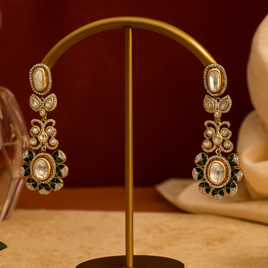 Ornate earrings on a gold stand with a warm background