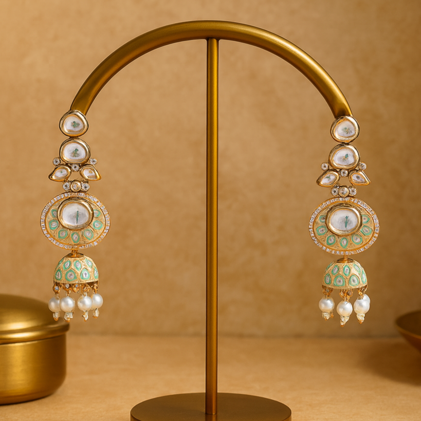 Ornate earrings on a gold stand against a beige background