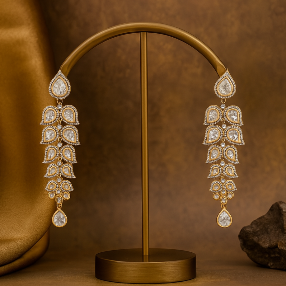 Pair of gold and diamond earrings on a brown stand with a brown background