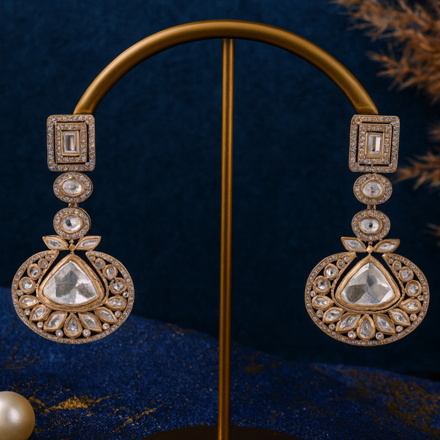 Ornate earrings on a stand with a dark blue background