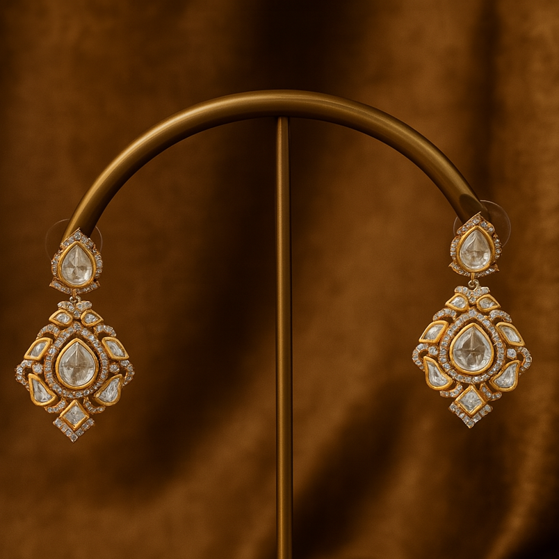 Ornate earrings on a brown stand with a brown fabric background