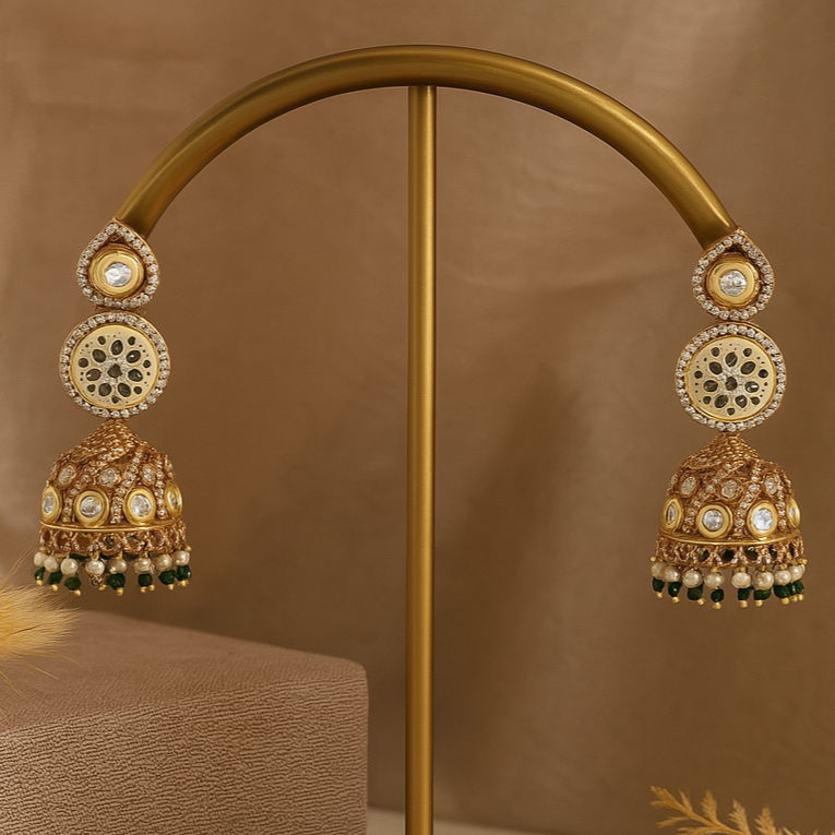 Gold earrings on a gold stand with a brown background