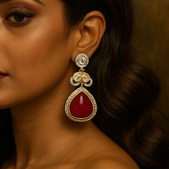 Woman wearing a red gemstone earring against a brown background