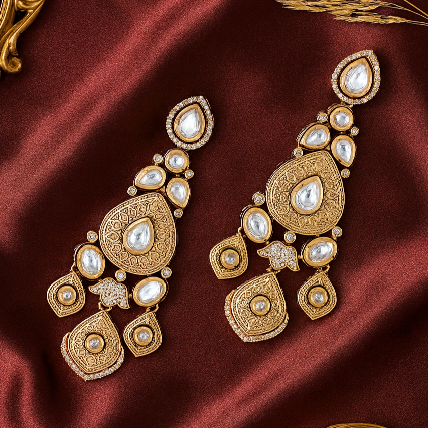 Gold and pearl earrings on a red satin background