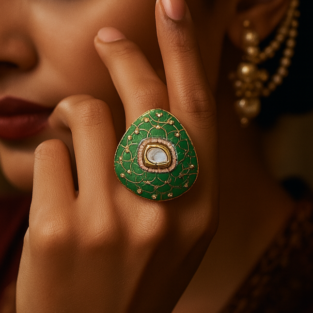 Woman wearing a green ring with intricate design, close-up shot.