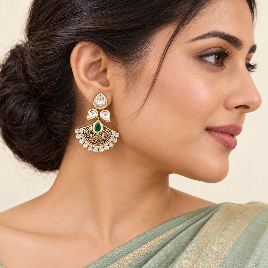 Indian model in a sage saree wearing a Kavya green and gold-tone floral chandbali earring, with hair swept back.
