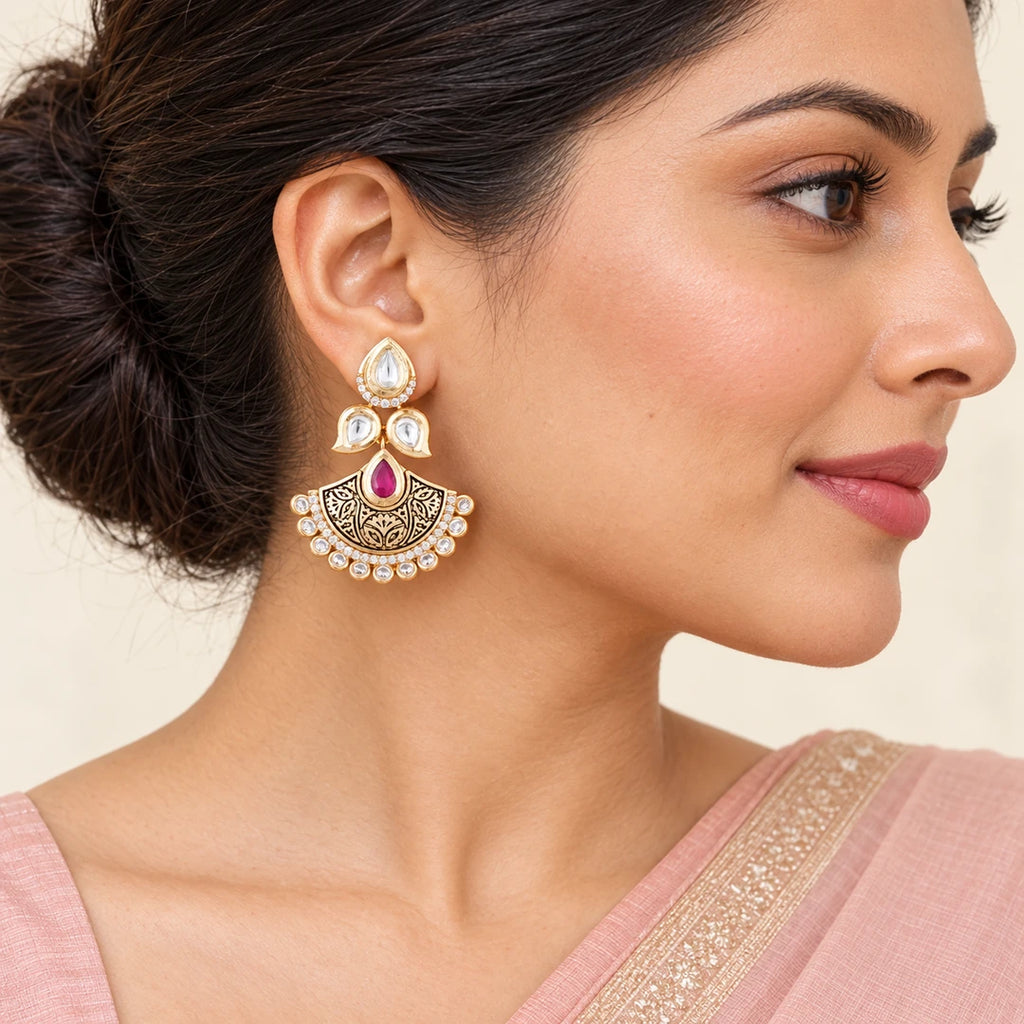 Indian model in a blush saree wearing a Kavya ruby-colour floral chandbali earring, with hair swept back.
