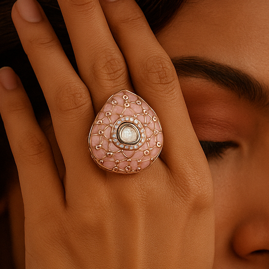 Close-up of a woman's face with a decorative ring on her finger against a warm brown background