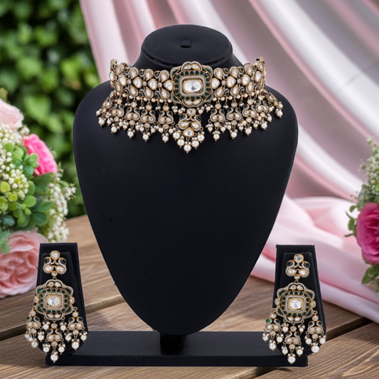 Ornate necklace and earrings set on a black stand with flowers in the background