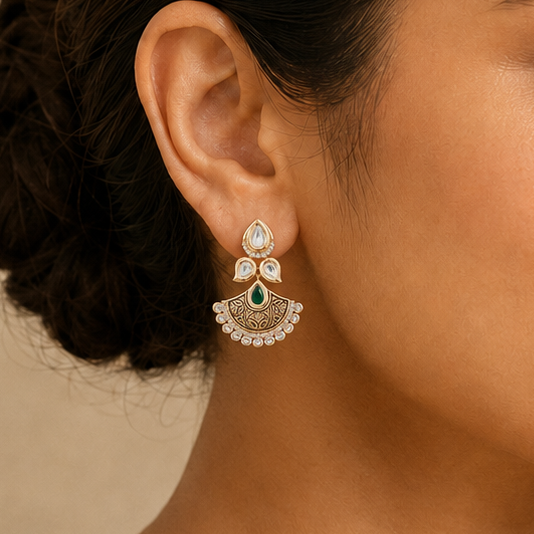 Model wearing an Aadhira antique Kundan fan earring with clear stones and an emerald-toned centre