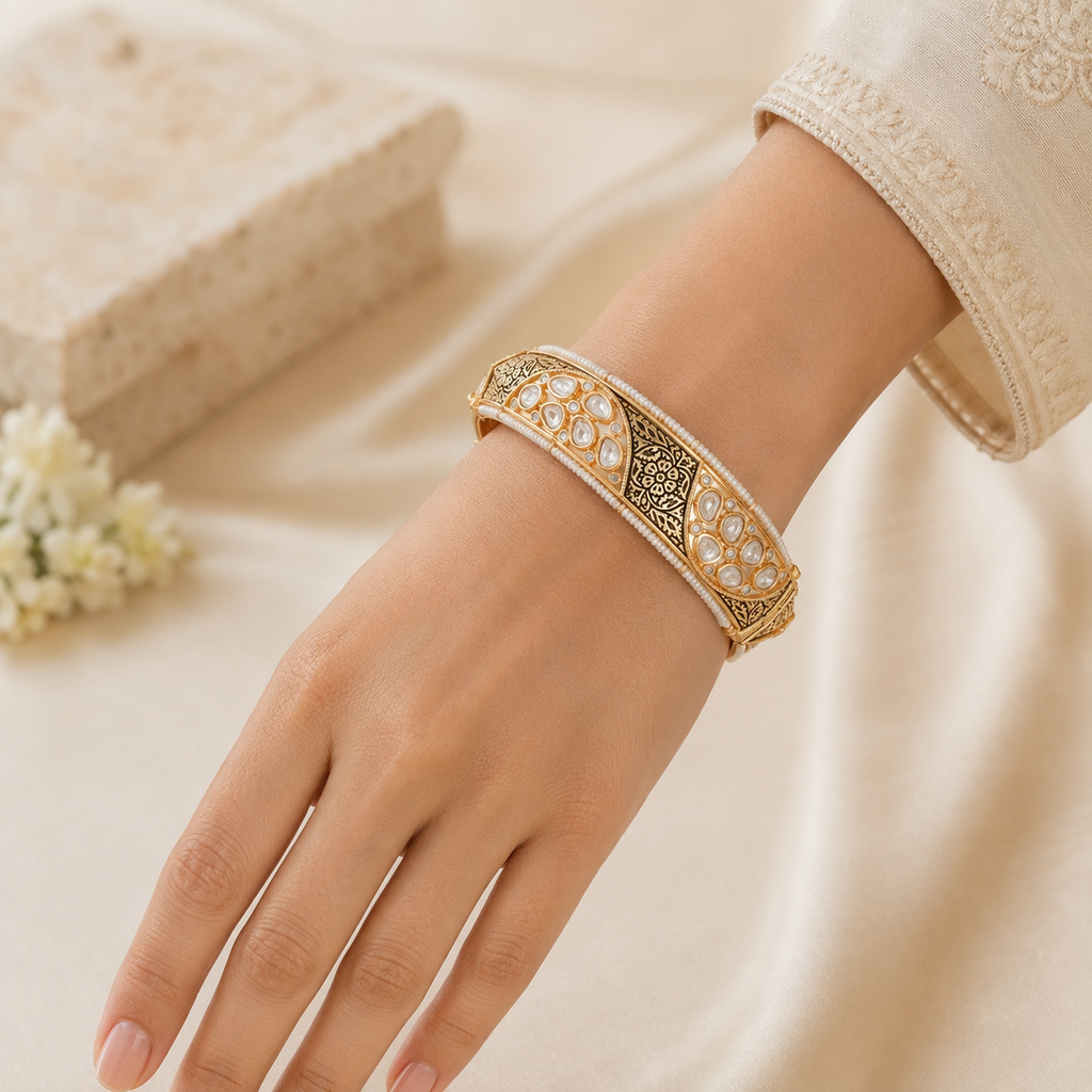 Antique gold Kundan-style kada bangle worn on a model’s wrist
