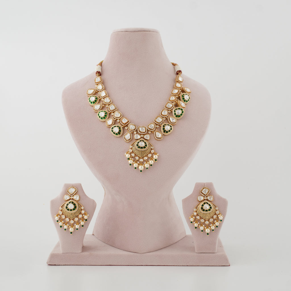 Aaranya gold-plated Kundan necklace set with green stones, white moti and matching earrings