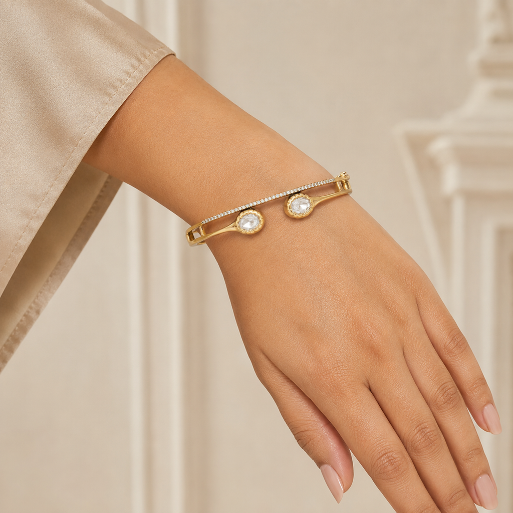Woman wearing Aarika gold Polki-style twin-stone bracelet on her wrist