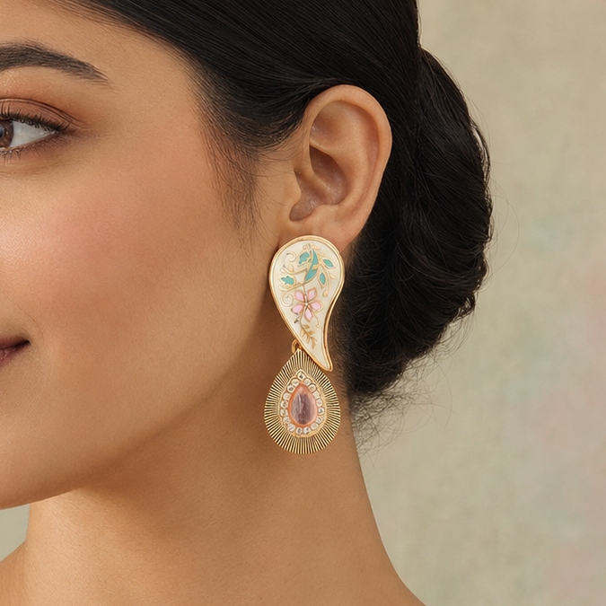 Model wearing an Aarini ivory Meenakari paisley earring with pastel floral and gold-tone detailing