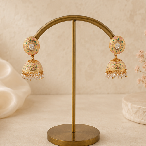 Aarini pastel meenakari pearl jhumka earrings displayed on a luxury ivory background