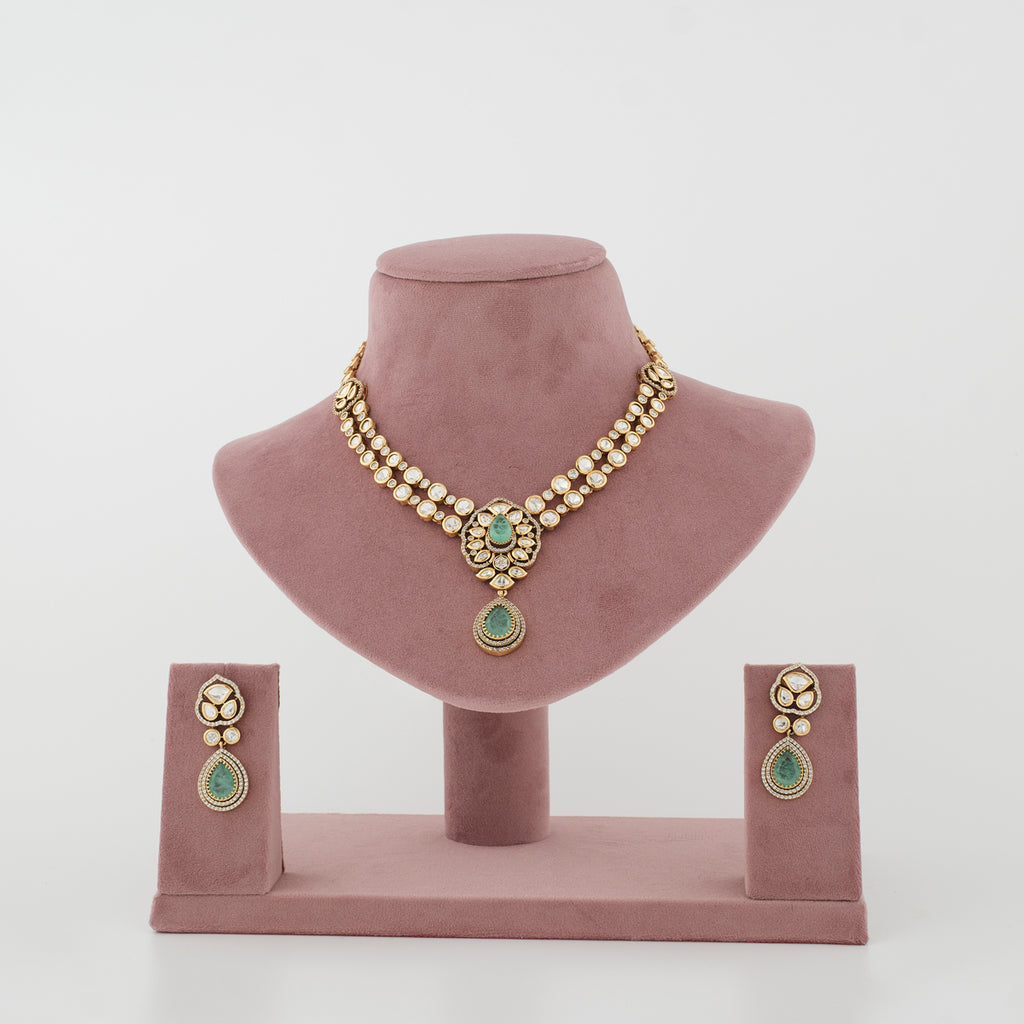 Aarshiya gold-tone artificial necklace set with mint teardrop stones and matching earrings