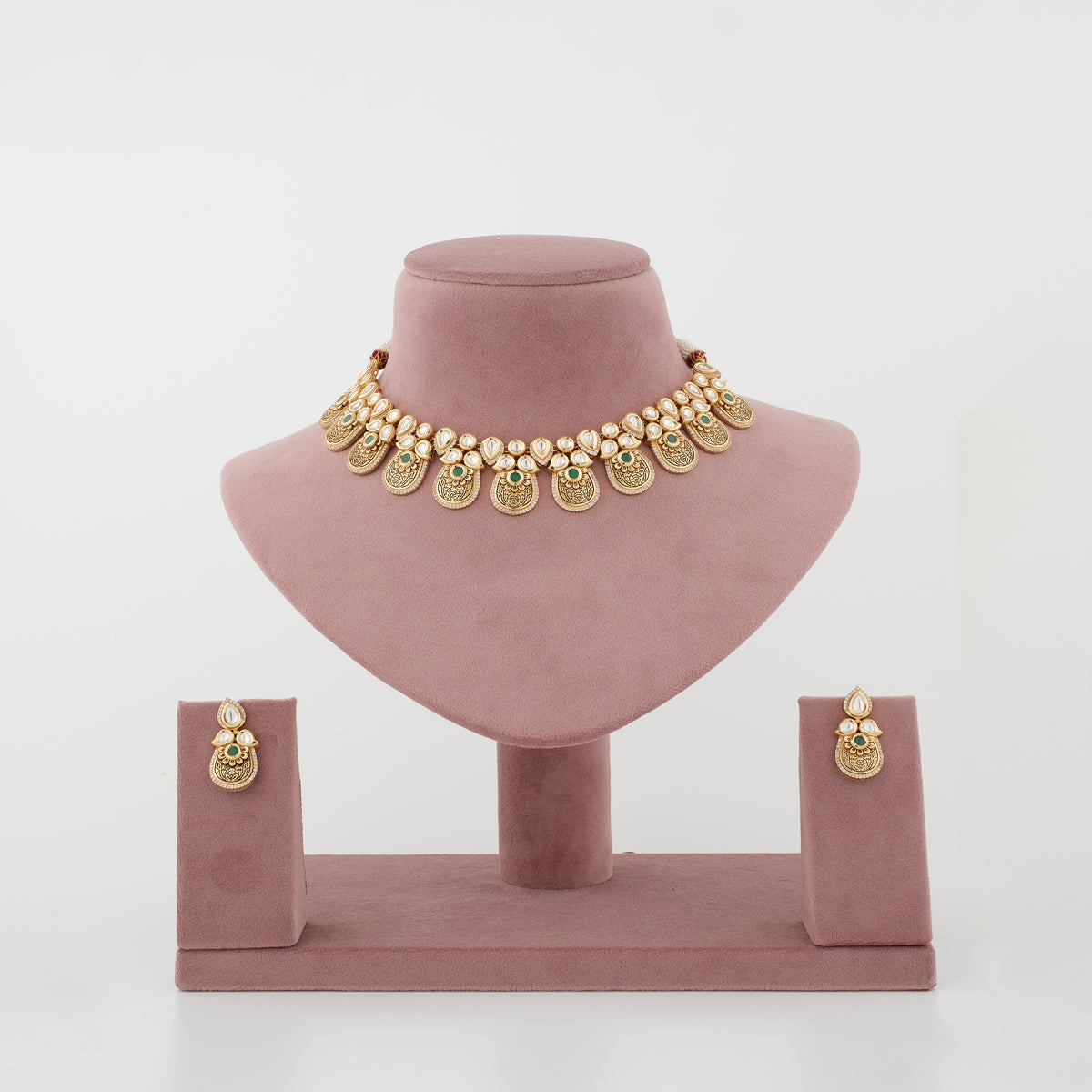 Aarunya antique gold artificial necklace set with diamond-look stones and emerald-green accents