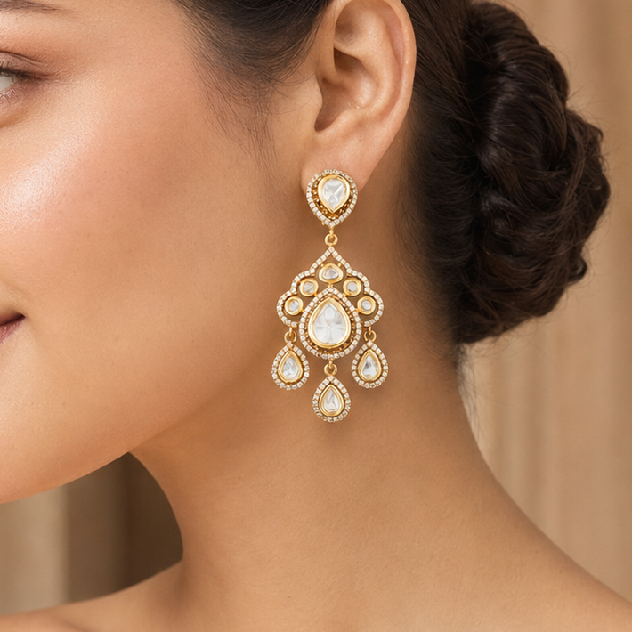 Model wearing Advika gold-finish Kundan chandelier earrings with sparkling clear stones