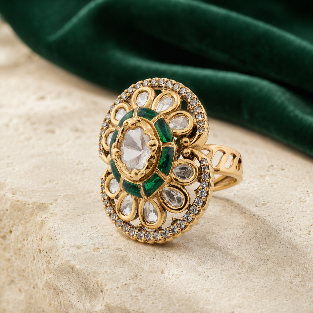 Green enamel floral statement ring displayed with deep-green fabric