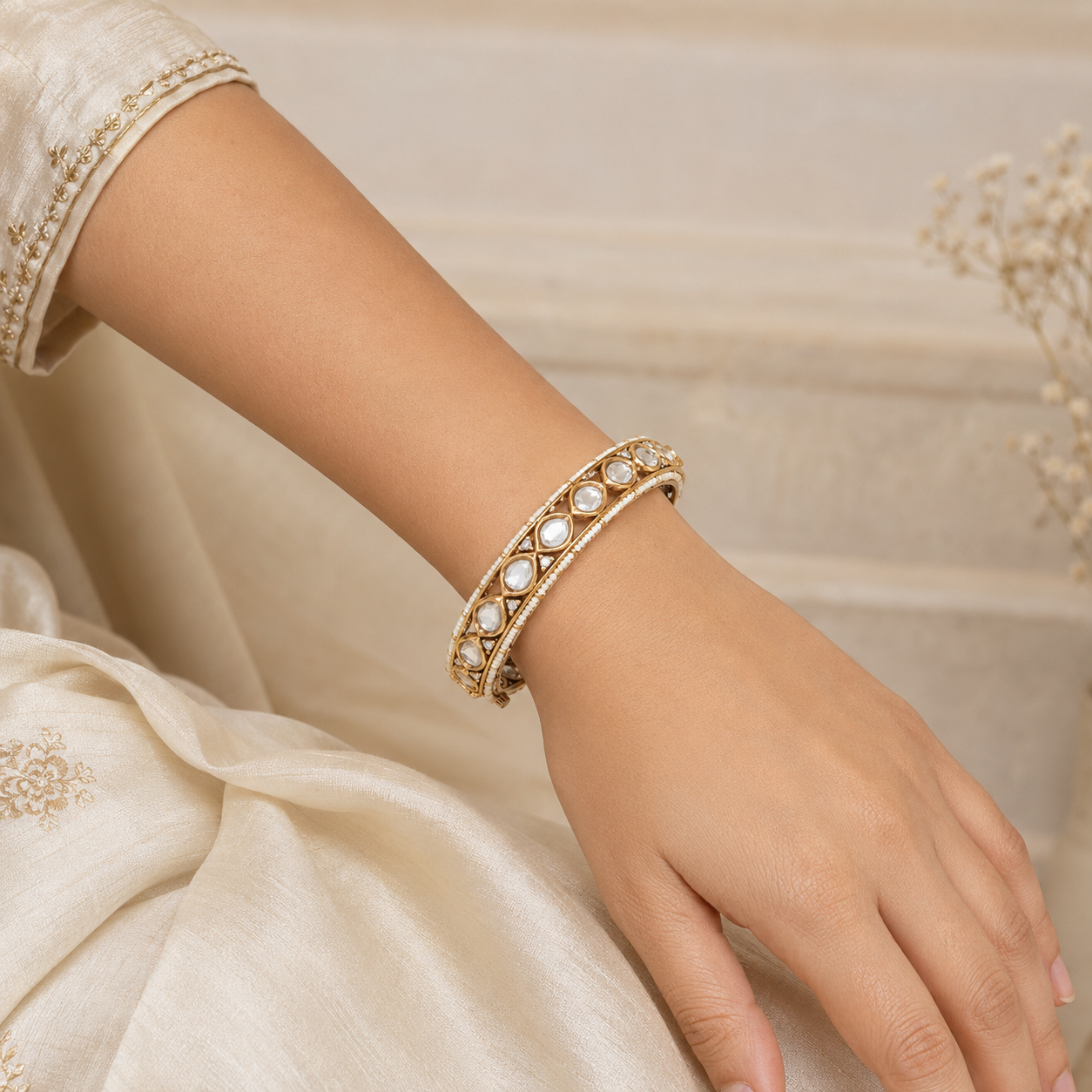 Woman wearing one Avni antique gold Kundan-style bracelet naturally on her wrist
