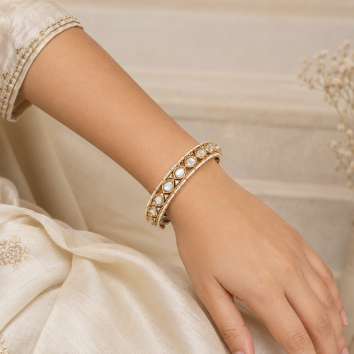 Woman wearing one Avni antique gold Kundan-style bracelet naturally on her wrist