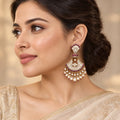 Indian model in a champagne saree wearing a Chandrika wine chandbali earring with clear stones and pearl-look drops.