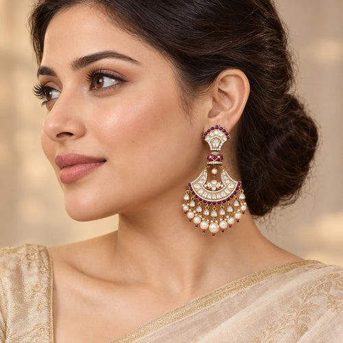 Indian model in a champagne saree wearing a Chandrika wine chandbali earring with clear stones and pearl-look drops.