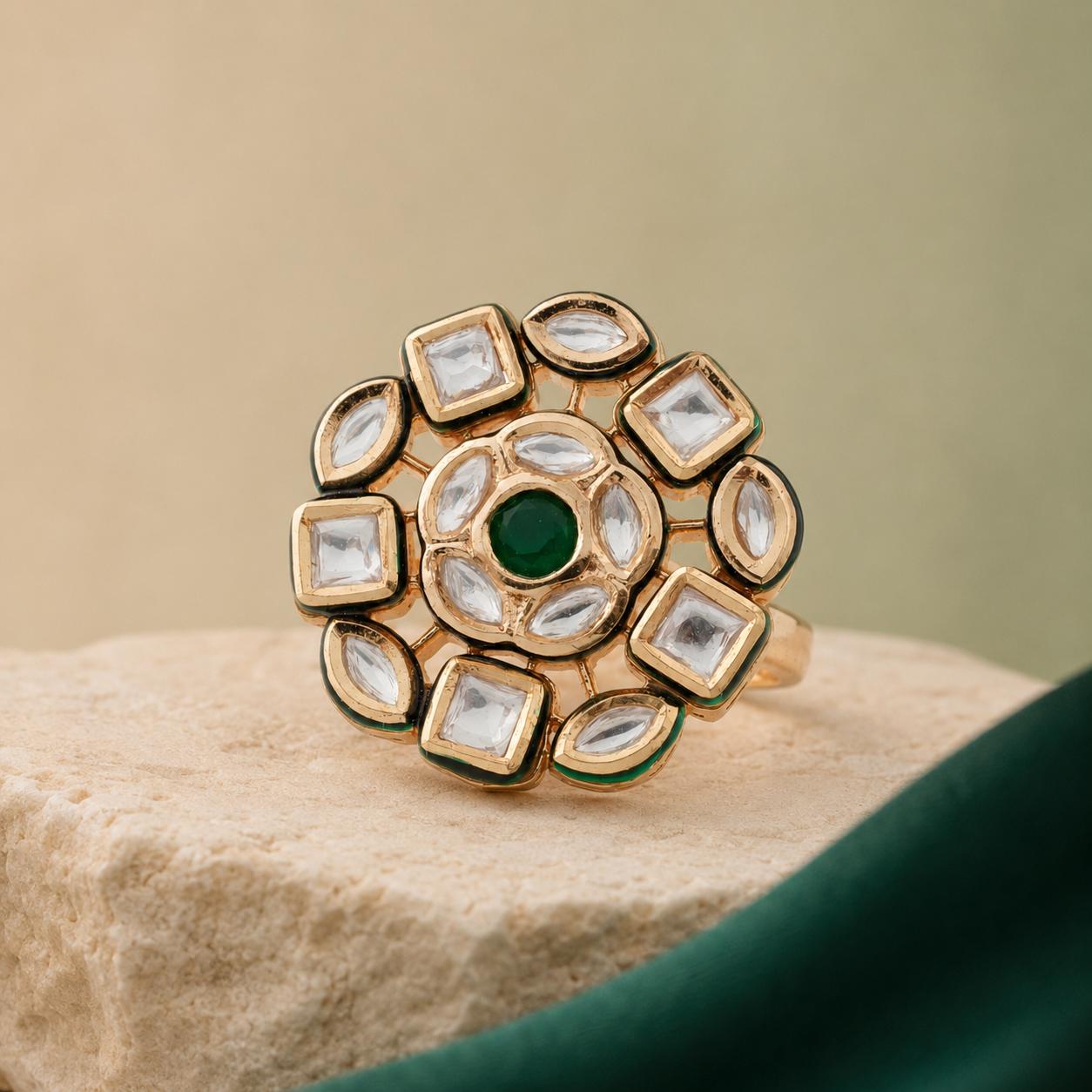 Gold-finish clear-stone statement ring displayed on a neutral pedestal