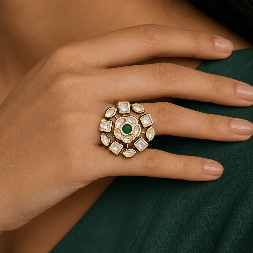 Woman wearing a circular Kundan-look statement ring with green centre