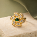 Gold-finish floral Kundan-look ring displayed on a neutral luxury surface