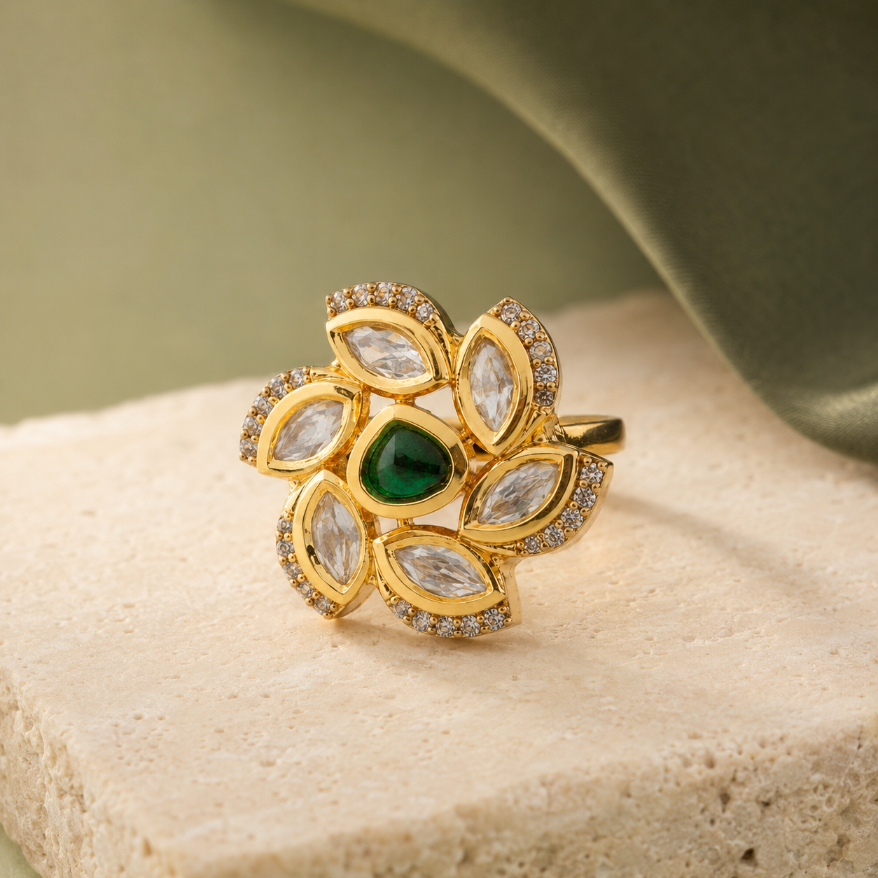 Gold-finish floral Kundan-look ring displayed on a neutral luxury surface