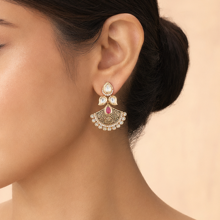 Model wearing a small Ishani antique Kundan fan earring with a pink teardrop centre