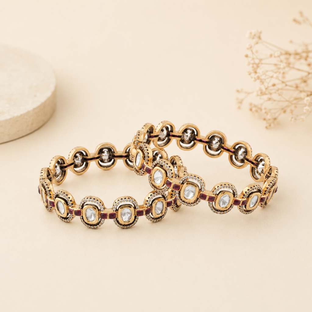 Ishani gold Kundan-style bangle pair displayed on a warm ivory luxury background