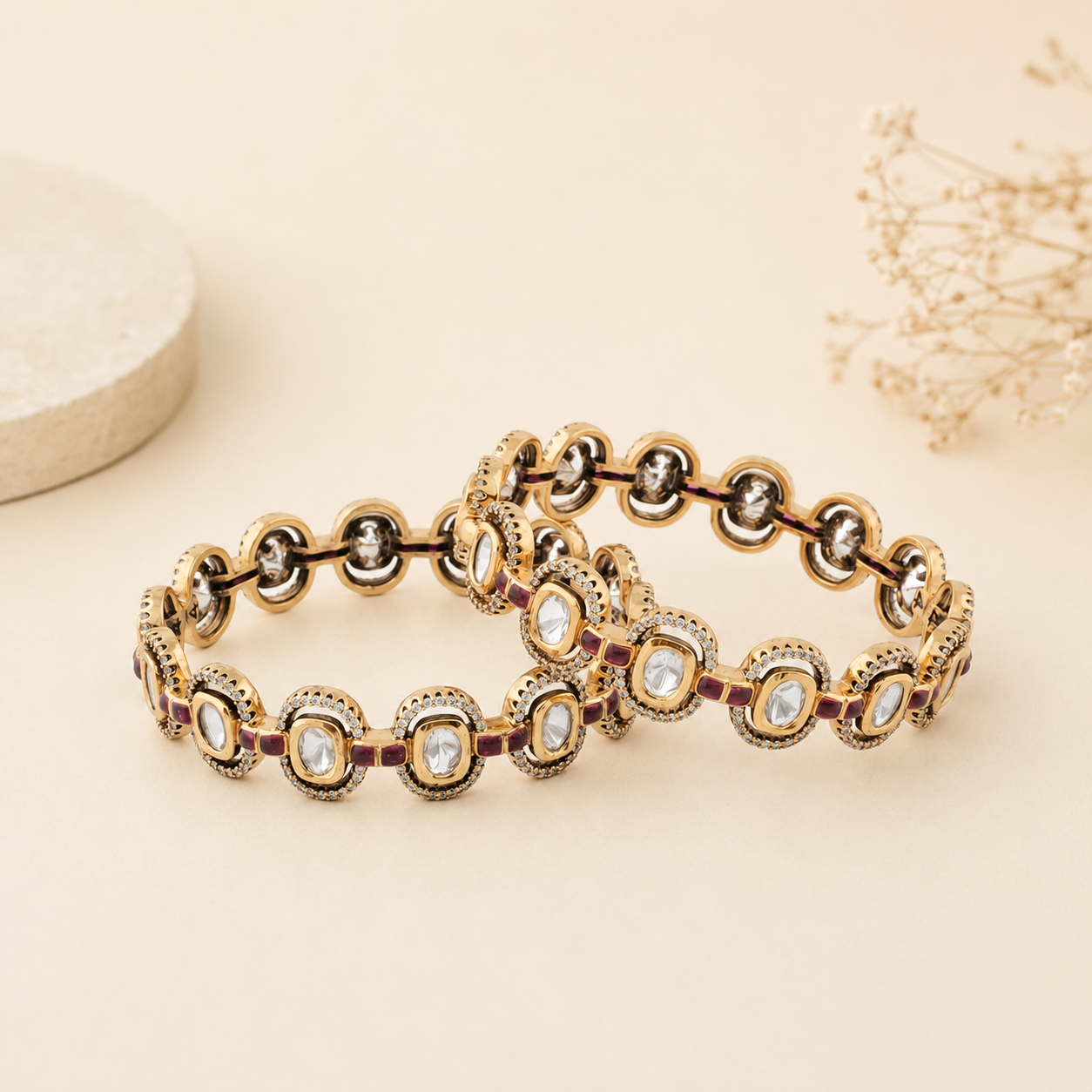 Ishani gold Kundan-style bangle pair displayed on a warm ivory luxury background
