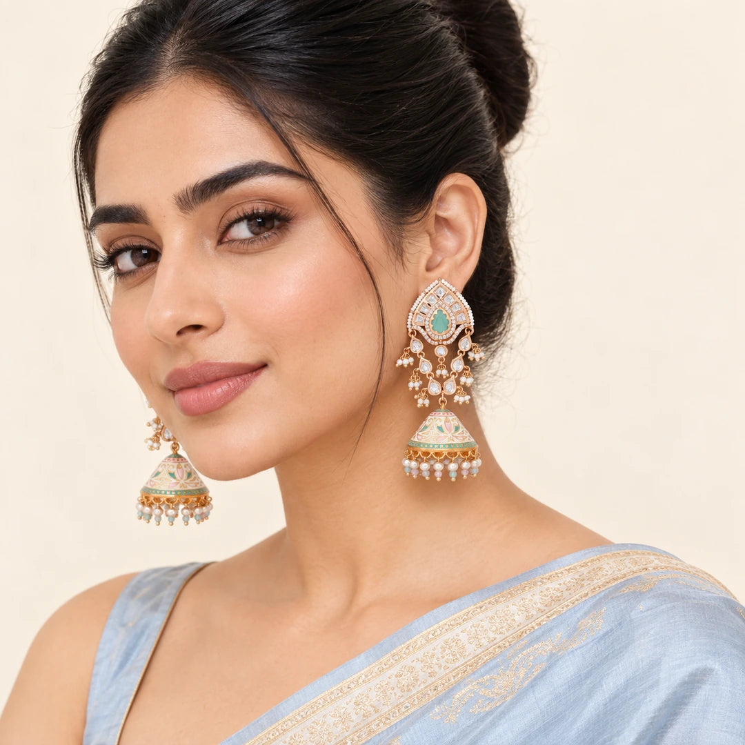 Indian model in a powder blue saree wearing Kanishka ivory and pastel long jhumka earrings with mint centres and floral domes.