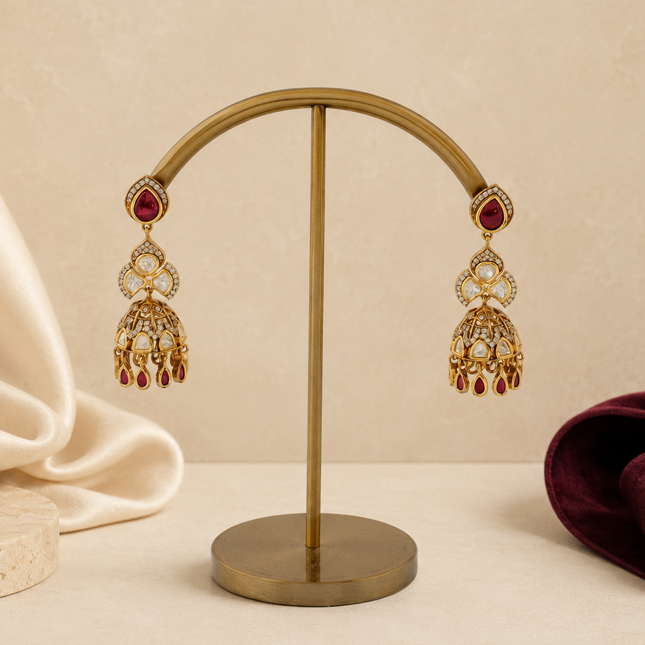 Kashvi gold polki-look floral jhumka earrings styled with ivory and wine-coloured props
