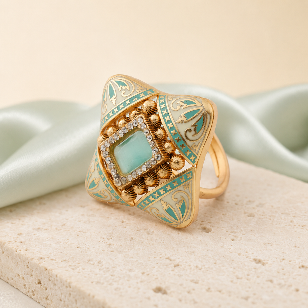 Kashvi gold-finish Meenakari cocktail ring displayed with mint fabric