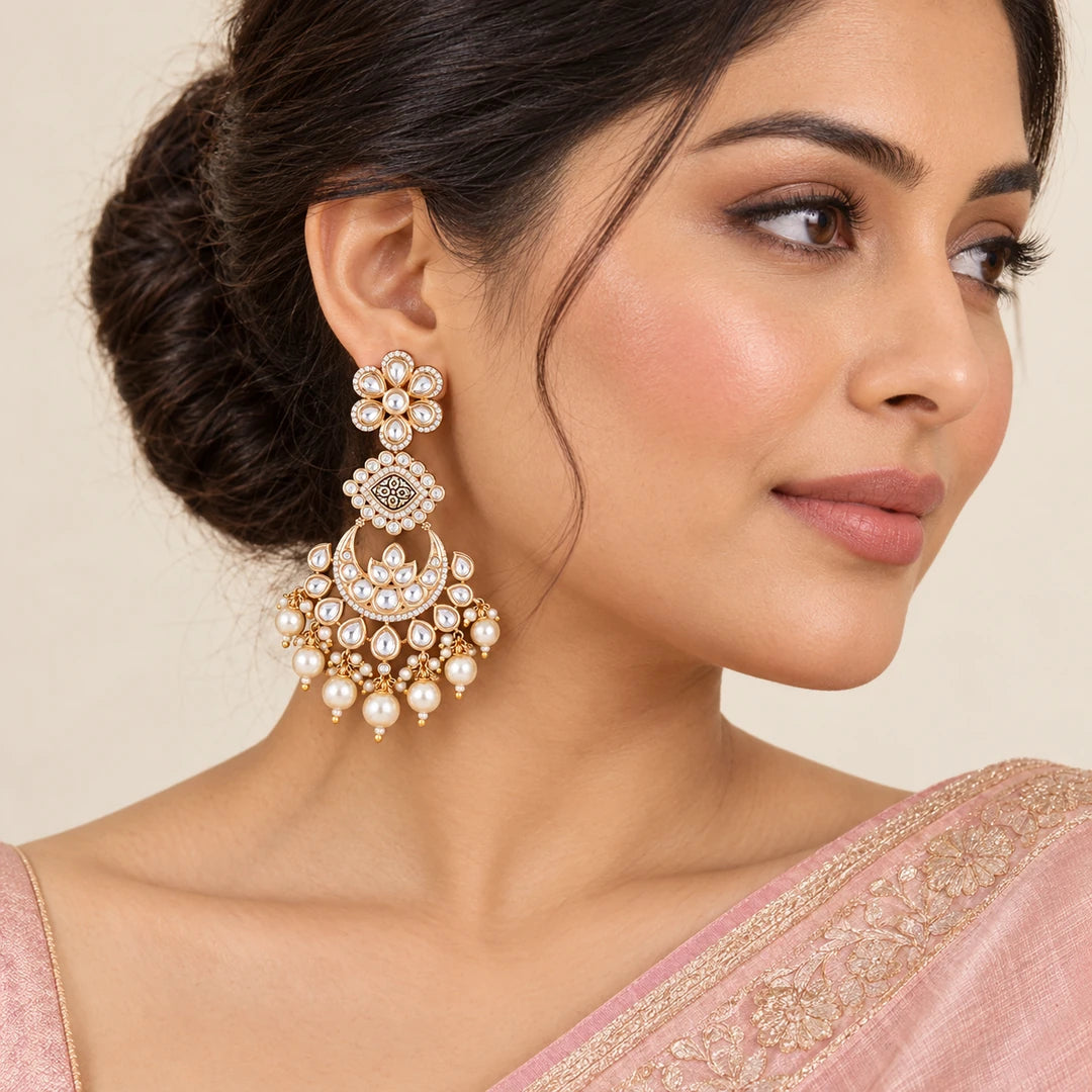 Indian model in a blush saree wearing a Kaumudi clear floral chandbali earring with cream pearl-style drops.