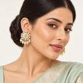 Indian model in a pale mint saree wearing Kavini ivory and mint earrings with clear floral borders and five cream pearl-style drops.