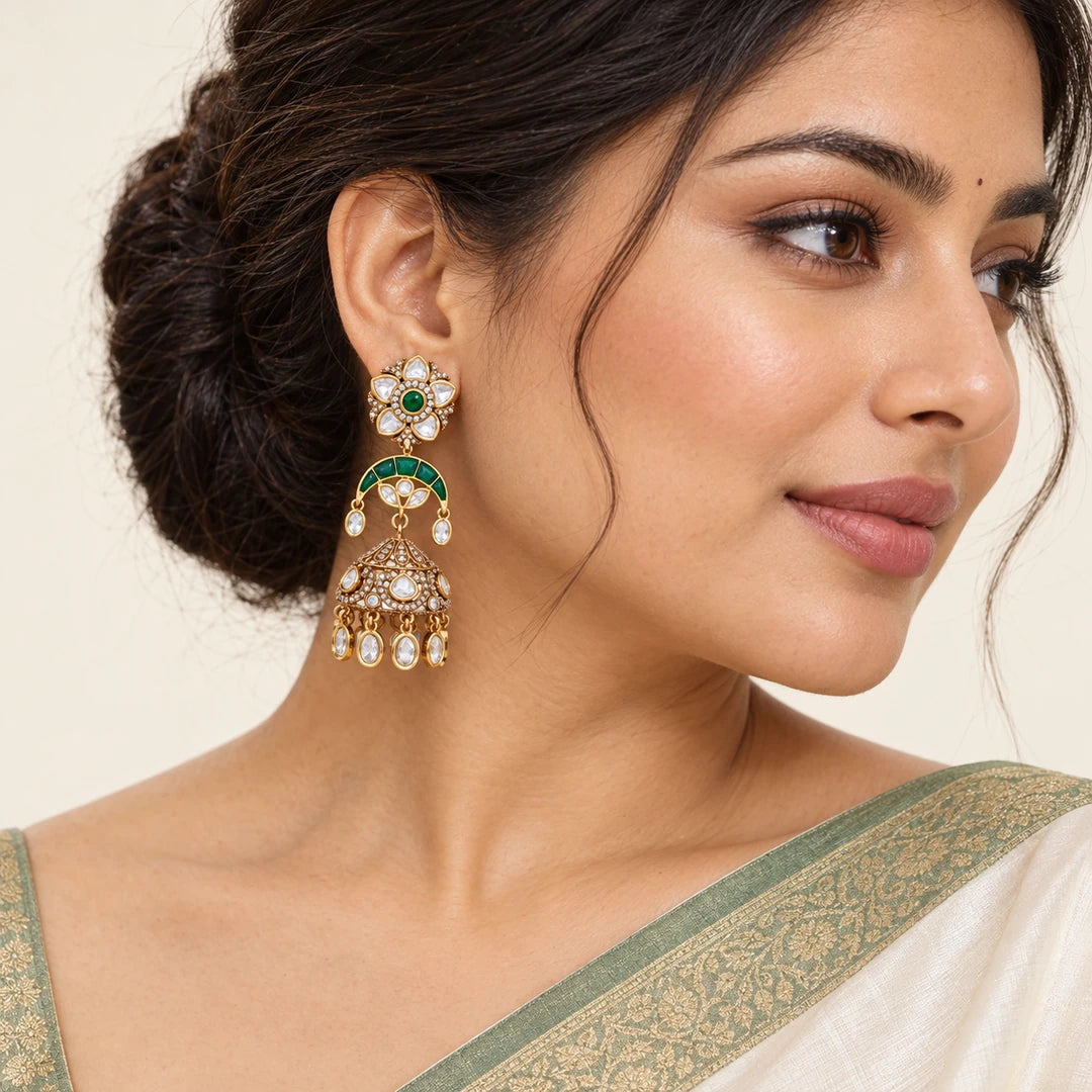 Indian model wearing a Keshavi green floral jhumka earring with an ivory saree and sage-green border.