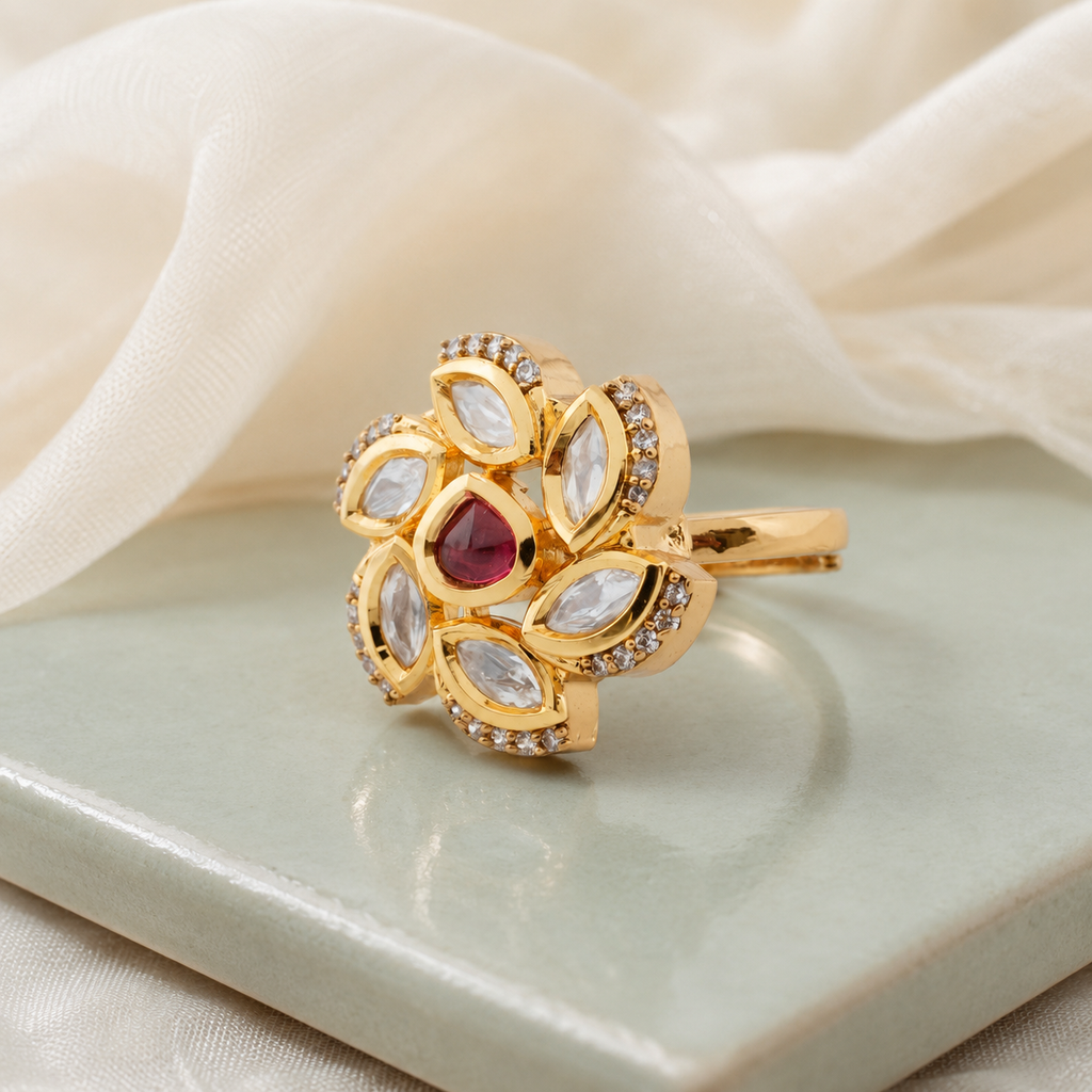 Gold-finish floral Kundan-look ring displayed on a soft neutral surface