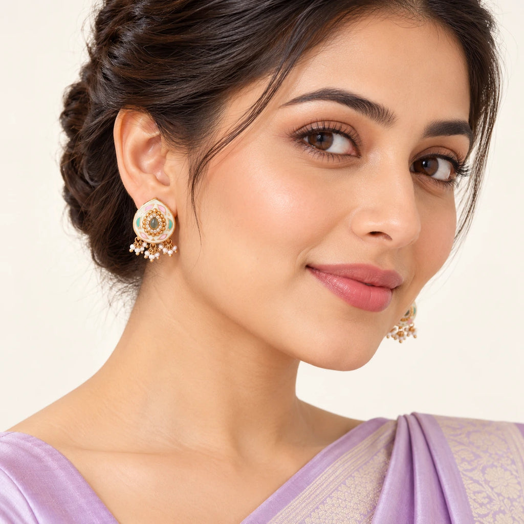 Indian model in a lavender saree wearing Kiyana ivory teardrop earrings with pastel leaf motifs and small white bead clusters.