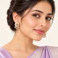 Indian model in a lavender saree wearing Kiyana ivory teardrop earrings with pastel leaf motifs and small white bead clusters.