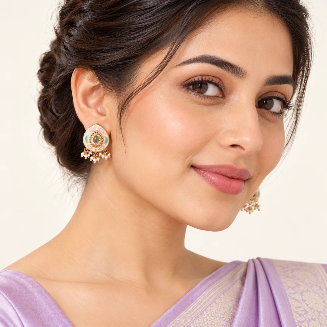 Indian model in a lavender saree wearing Kiyana ivory teardrop earrings with pastel leaf motifs and small white bead clusters.
